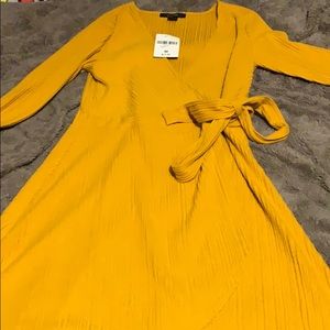 Mustard Long sleeve dress flowing at the bottom